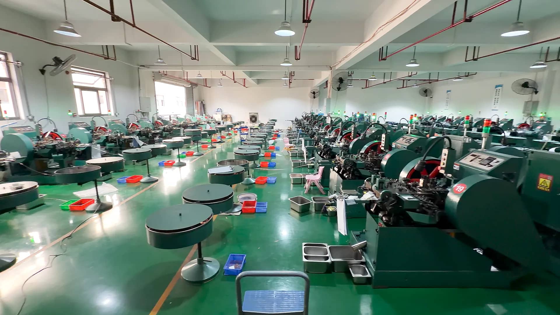 Electrical contact production workshop with manufacturing equipment arranged across the floor.