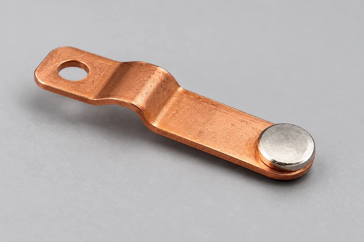 A silver contact mounted on a formed copper support.