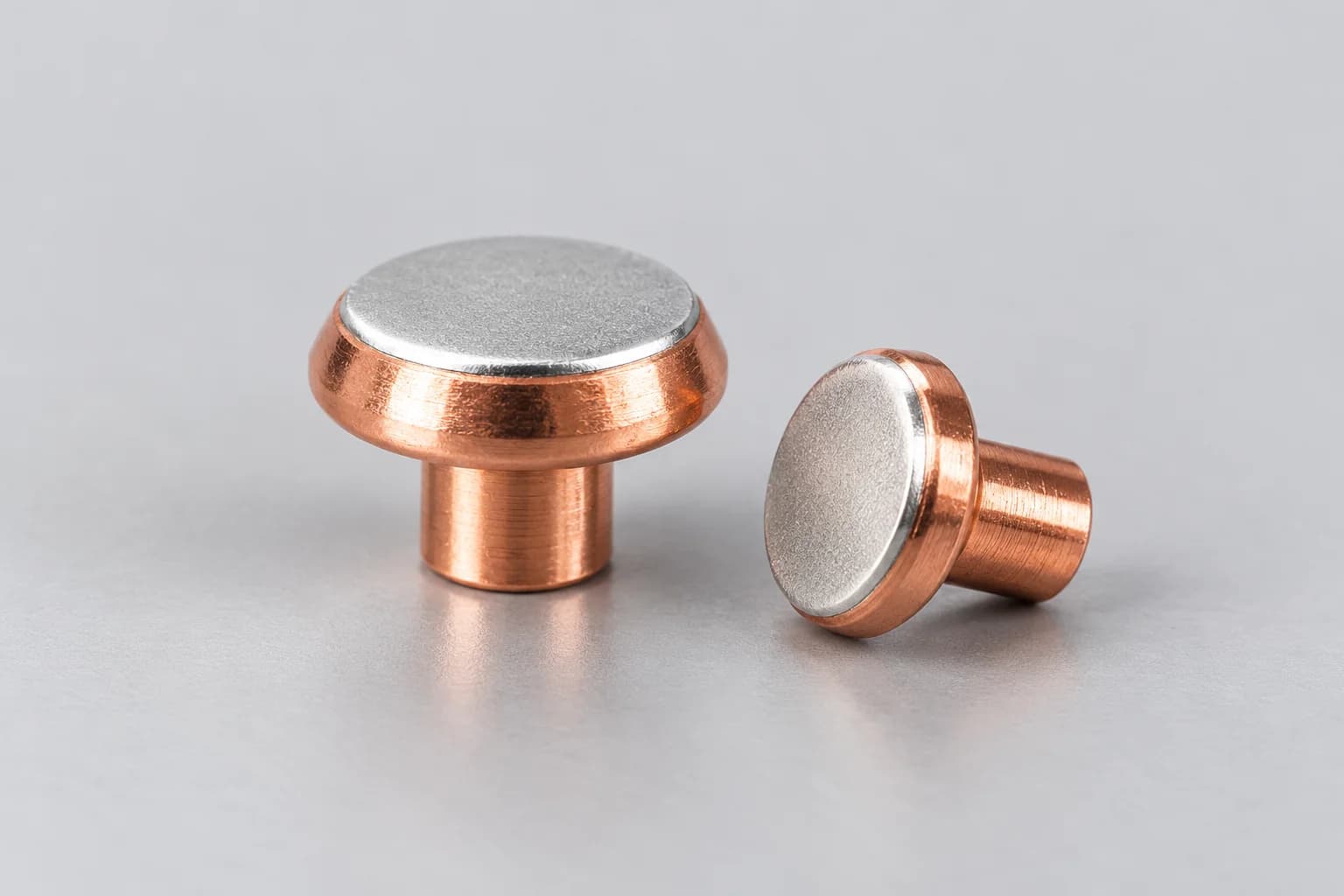 Silver contact material bonded to a copper base.