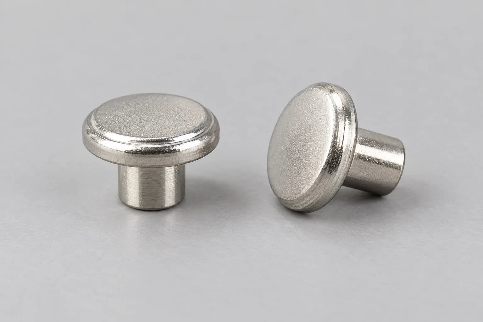 Solid electrical contact rivets with integral heads and shanks.