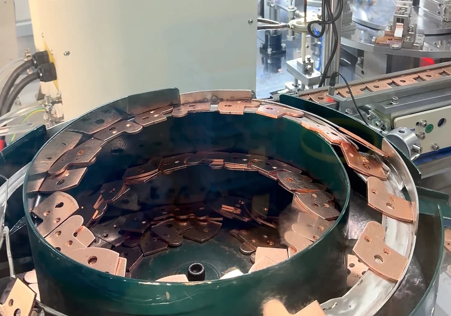 A component feeding area and production equipment shown in context.