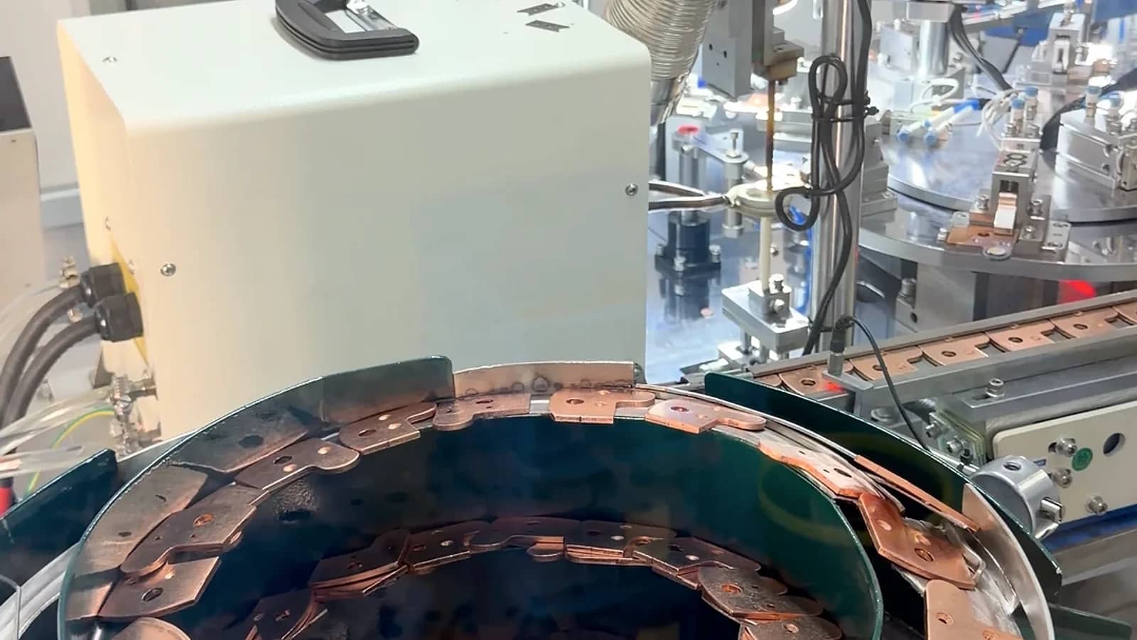 Contact strips moving through a component feeding station.
